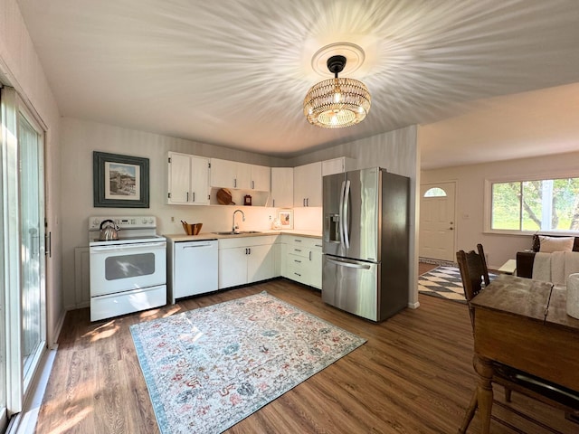 285 Brookside Dr, Ann Arbor, MI 48105 - kitchen with white appliances, a chandelier, light countertops, dark wood-style flooring, and white cabinets