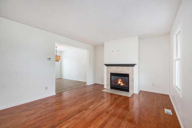 1882 Whistle Stop Dr SE, Grand Rapids, MI 49508 - unfurnished living room with hardwood / wood-style flooring and a tile fireplace