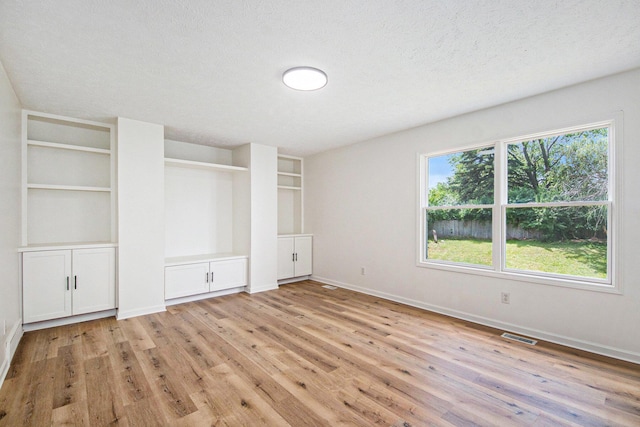 1882 Whistle Stop Dr SE, Grand Rapids, MI 49508 - unfurnished bedroom featuring light wood-style flooring and a textured ceiling