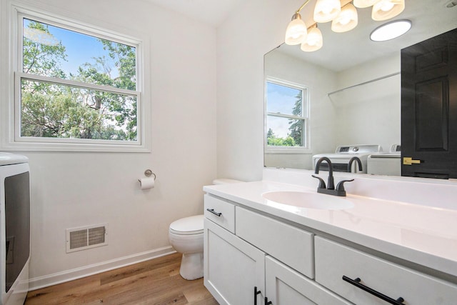 1882 Whistle Stop Dr SE, Grand Rapids, MI 49508 - bathroom featuring washer / dryer, vanity, and wood finished floors