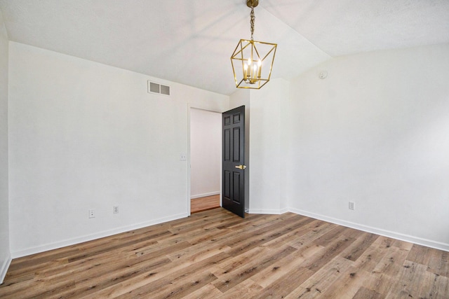 1882 Whistle Stop Dr SE, Grand Rapids, MI 49508 - empty room featuring lofted ceiling, a chandelier, and light wood finished floors