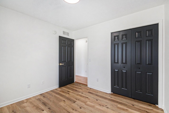 1882 Whistle Stop Dr SE, Grand Rapids, MI 49508 - unfurnished bedroom featuring light wood-type flooring and a closet