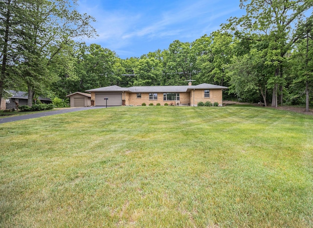 6667 W River Rd NE, Belmont, MI 49306 - ranch-style house featuring driveway, a chimney, brick siding, a front yard, and a garage