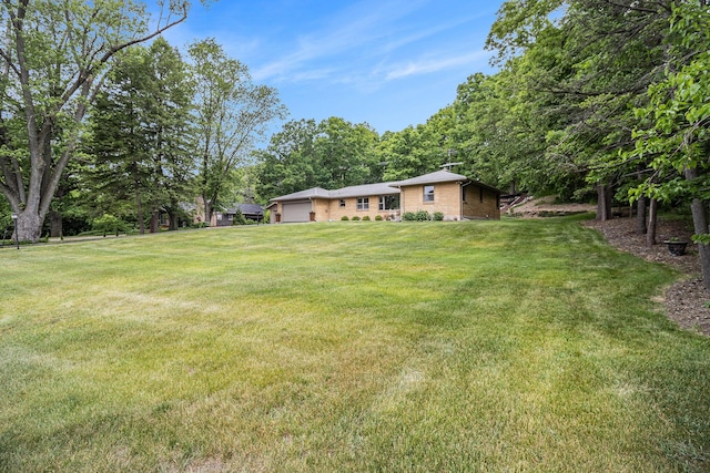 6667 W River Rd NE, Belmont, MI 49306 - view of grassy yard with an attached garage