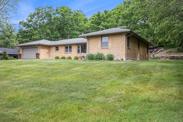 6667 W River Rd NE, Belmont, MI 49306 - view of front of property with an attached garage, brick siding, and a front yard