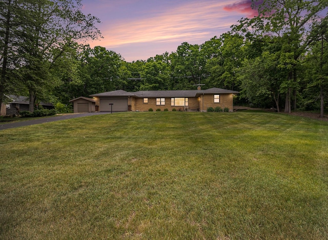 6667 W River Rd NE, Belmont, MI 49306 - ranch-style house with driveway, a front lawn, brick siding, a garage, and a chimney