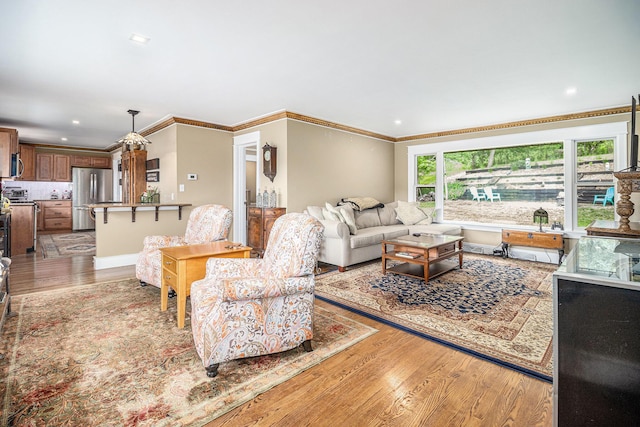 6667 W River Rd NE, Belmont, MI 49306 - living area featuring light wood-style flooring, crown molding, and recessed lighting