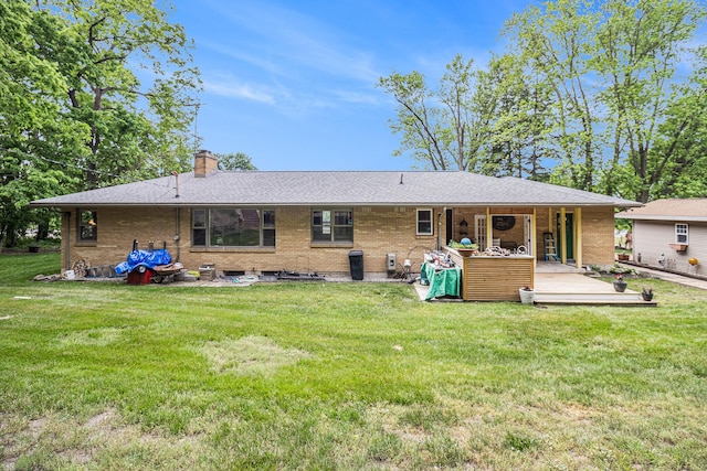 6667 W River Rd NE, Belmont, MI 49306 - back of house with brick siding, a chimney, a yard, and a shingled roof