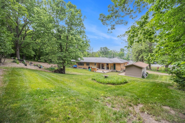 6667 W River Rd NE, Belmont, MI 49306 - view of front of home with a front lawn and brick siding