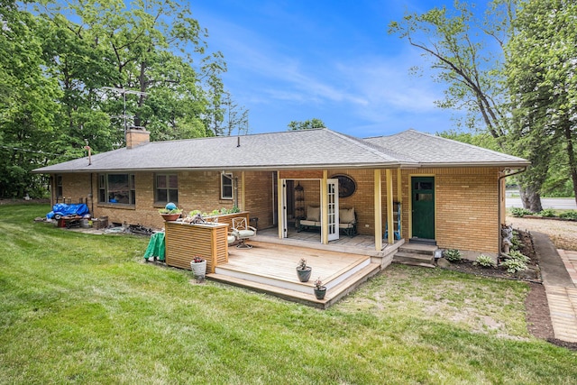 6667 W River Rd NE, Belmont, MI 49306 - rear view of house with brick siding, a chimney, a lawn, a shingled roof, and a wooden deck