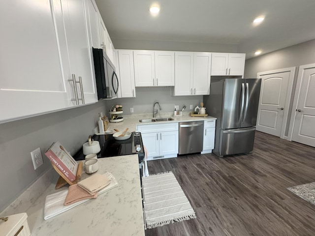 891 Rex St, Fremont, MI 49412 - kitchen featuring appliances with stainless steel finishes, white cabinets, recessed lighting, and dark wood-style flooring