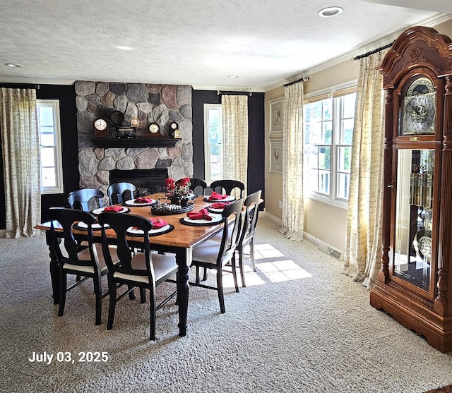 1033 Lumina Dr, Jenison, MI 49428 - dining room featuring crown molding, carpet flooring, a textured ceiling, and a fireplace