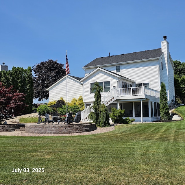 1033 Lumina Dr, Jenison, MI 49428 - rear view of house featuring stairs, a wooden deck, a yard, a chimney, and a patio area