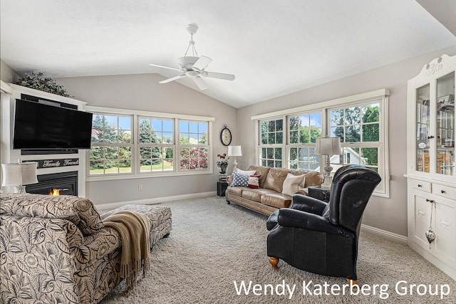 1033 Lumina Dr, Jenison, MI 49428 - living area with carpet, lofted ceiling, a ceiling fan, and a warm lit fireplace