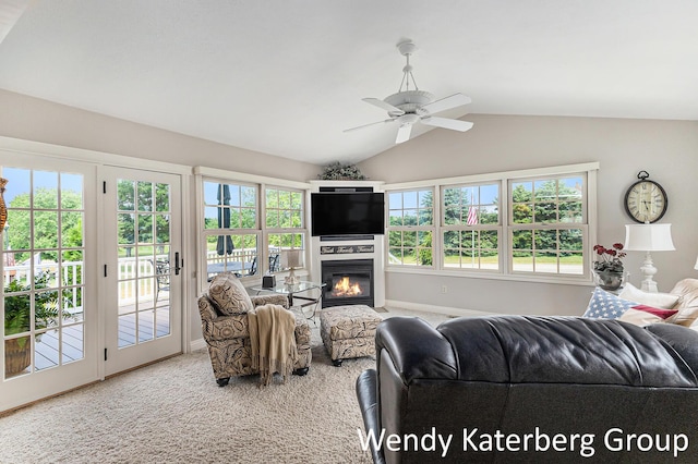 1033 Lumina Dr, Jenison, MI 49428 - carpeted living room featuring vaulted ceiling, a ceiling fan, and a glass covered fireplace