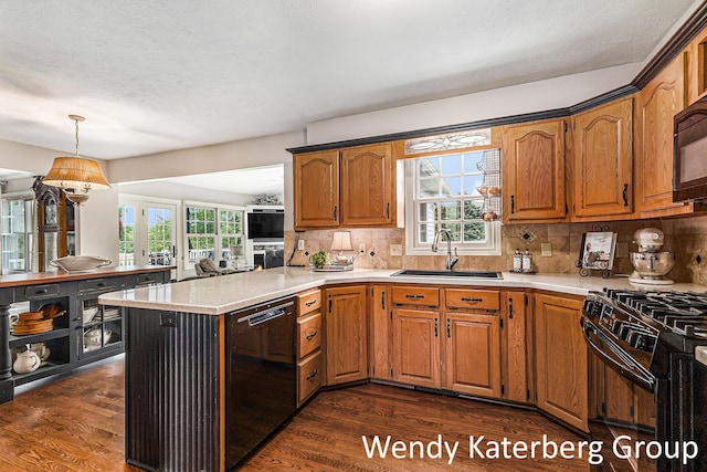 1033 Lumina Dr, Jenison, MI 49428 - kitchen featuring black appliances, light countertops, dark wood finished floors, tasteful backsplash, and a textured ceiling