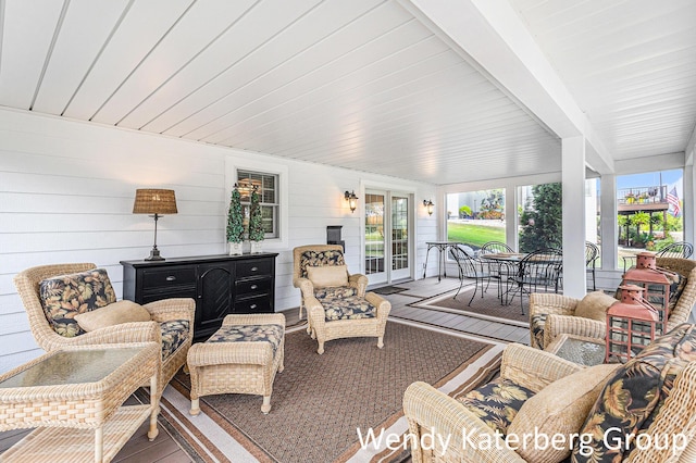 1033 Lumina Dr, Jenison, MI 49428 - sunroom with plenty of natural light, wood finished floors, beam ceiling, wooden walls, and french doors