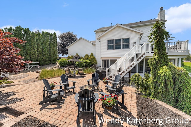 1033 Lumina Dr, Jenison, MI 49428 - view of patio with an outdoor fire pit, stairs, and a wooden deck