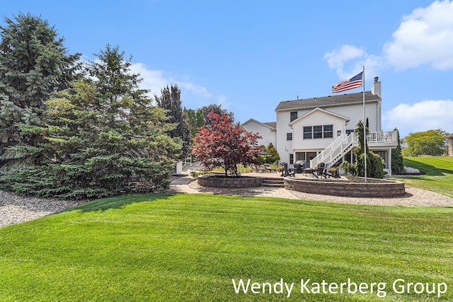 1033 Lumina Dr, Jenison, MI 49428 - back of property featuring stairs, a patio area, a lawn, a wooden deck, and a chimney