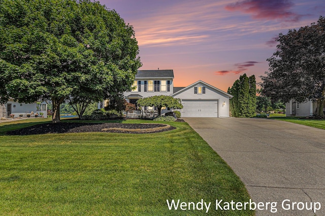 1033 Lumina Dr, Jenison, MI 49428 - traditional home featuring concrete driveway, a lawn, a garage, and a porch