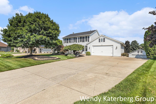 1033 Lumina Dr, Jenison, MI 49428 - colonial house featuring a front yard, concrete driveway, and a garage