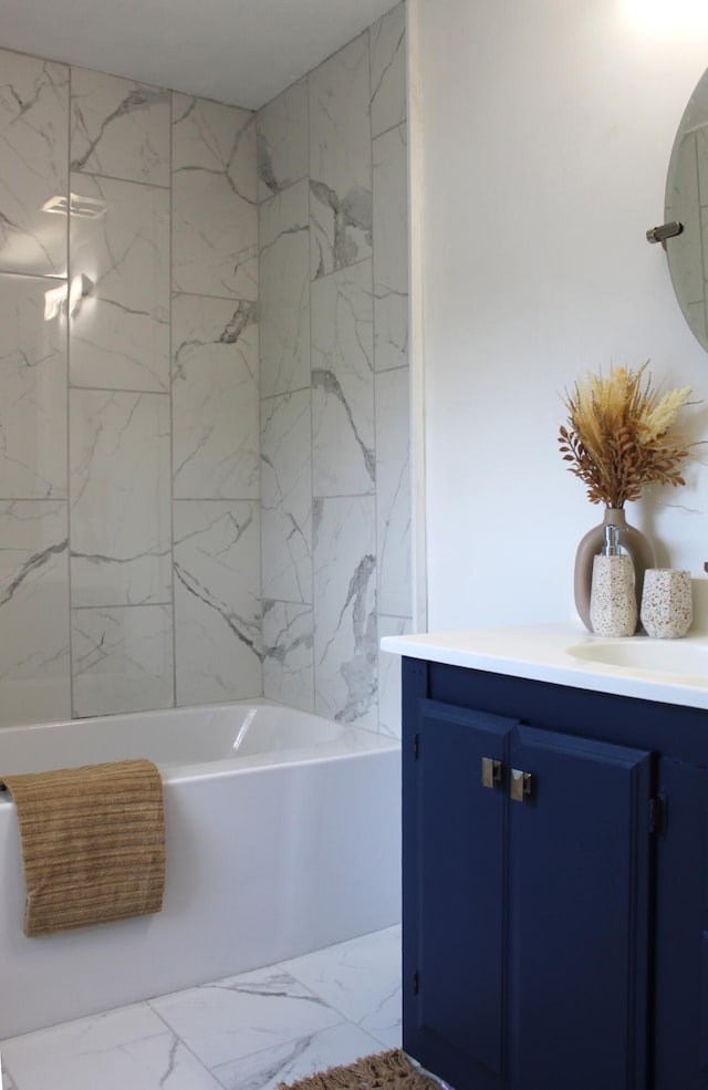 1608 S Rose St, Kalamazoo, MI 49001 - bathroom with marble look tiles, vanity, and bathtub / shower combination