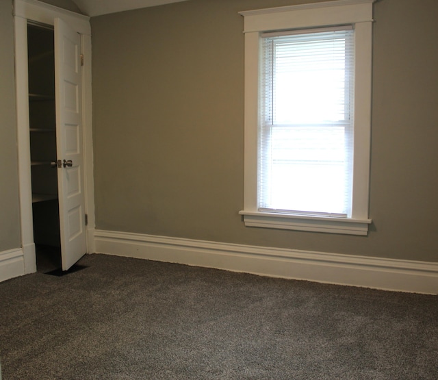 1608 S Rose St, Kalamazoo, MI 49001 - empty room featuring dark carpet and plenty of natural light
