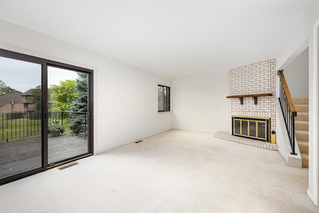 2623 Meade Ct, Ann Arbor, MI 48105 - unfurnished living room featuring carpet flooring, a fireplace, and stairway