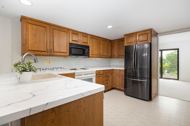 2623 Meade Ct, Ann Arbor, MI 48105 - kitchen featuring freestanding refrigerator, black microwave, electric stove, brown cabinetry, and recessed lighting