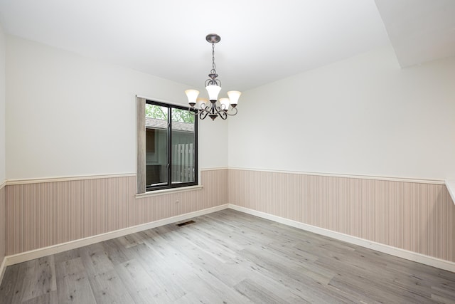 2623 Meade Ct, Ann Arbor, MI 48105 - unfurnished room featuring wood finished floors, a chandelier, and a wainscoted wall