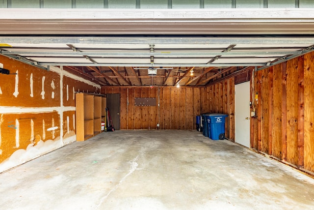 2623 Meade Ct, Ann Arbor, MI 48105 - garage with a garage door opener and wooden walls