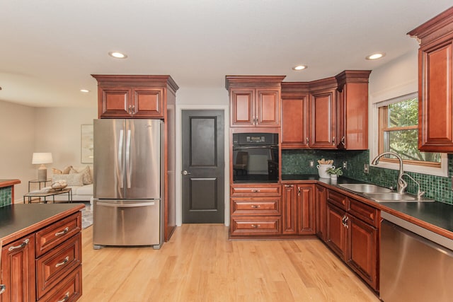 7532 Dell Rd, Saline, MI 48176 - kitchen with appliances with stainless steel finishes, dark countertops, light wood-style floors, decorative backsplash, and recessed lighting