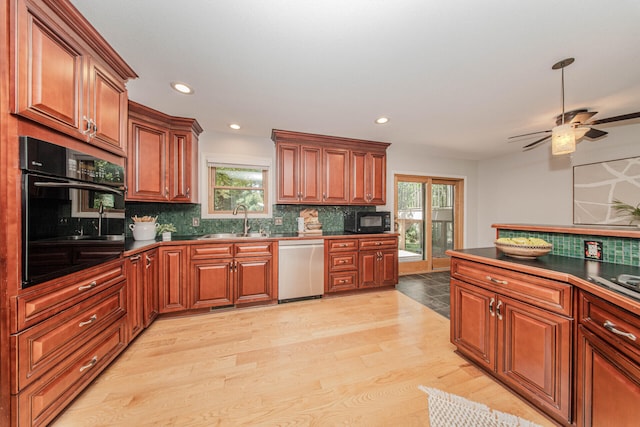 7532 Dell Rd, Saline, MI 48176 - kitchen featuring black appliances, tasteful backsplash, plenty of natural light, and recessed lighting