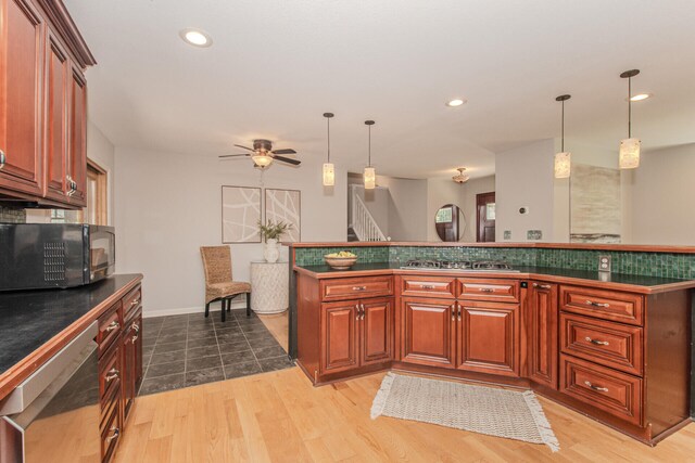 7532 Dell Rd, Saline, MI 48176 - kitchen featuring stainless steel appliances, dark countertops, a ceiling fan, light wood finished floors, and recessed lighting