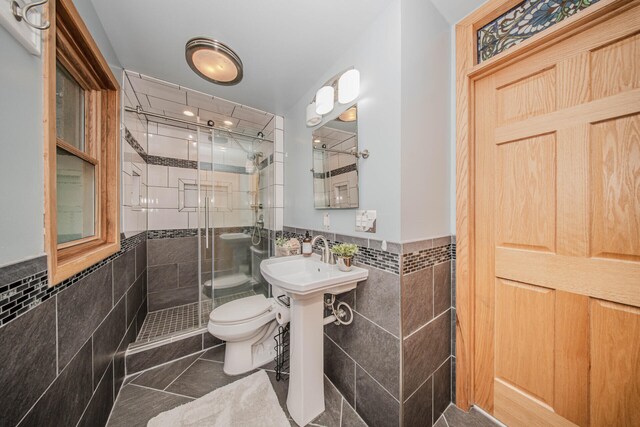 7532 Dell Rd, Saline, MI 48176 - full bathroom featuring tile walls, a shower stall, a wainscoted wall, and tile patterned floors