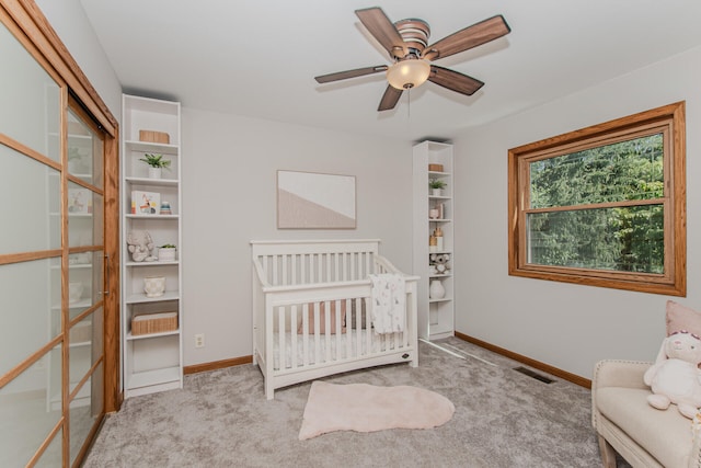 7532 Dell Rd, Saline, MI 48176 - bedroom featuring carpet flooring, ceiling fan, and a crib