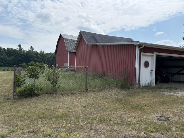 22347 5 Mile Rd, Morley, MI 49336 - view of property exterior featuring a garage and an outbuilding