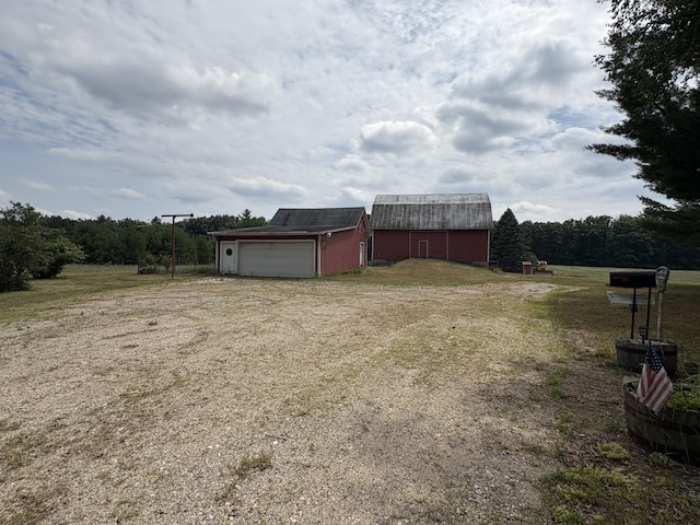 22347 5 Mile Rd, Morley, MI 49336 - view of yard with driveway, an outdoor structure, a barn, and a garage