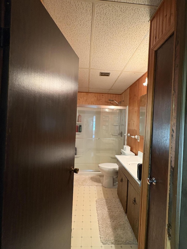 22347 5 Mile Rd, Morley, MI 49336 - bathroom with a shower stall, wooden walls, vanity, tile patterned floors, and a drop ceiling