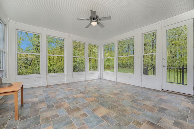 9266 Maricopa Trl, Kalamazoo, MI 49009 - unfurnished sunroom with stone finish floors and a decorative wall