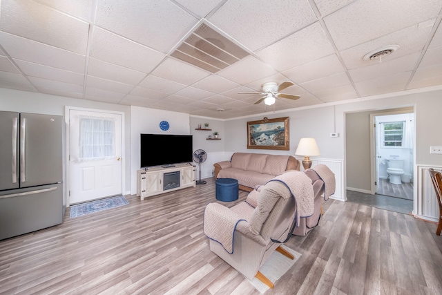 1051 Vallado Dr, Weidman, MI 48893 - living area featuring a paneled ceiling, light wood-style floors, and a ceiling fan