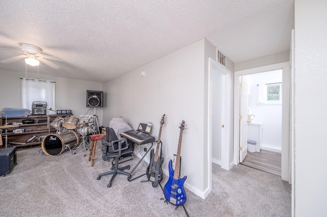 1051 Vallado Dr, Weidman, MI 48893 - home office with carpet flooring, a textured ceiling, and a ceiling fan