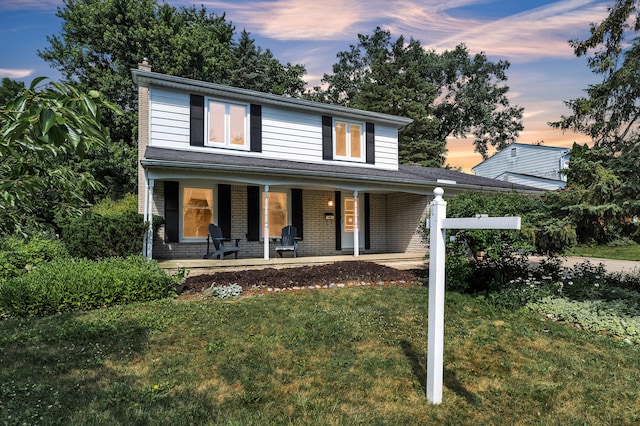2145 Steeplechase Dr, Ann Arbor, MI 48103 - view of front facade featuring a lawn, a porch, brick siding, and a chimney