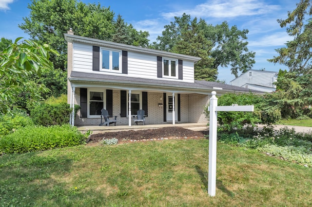 2145 Steeplechase Dr, Ann Arbor, MI 48103 - view of front of house with a front lawn, a porch, a chimney, and brick siding