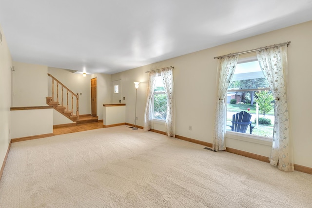 2145 Steeplechase Dr, Ann Arbor, MI 48103 - unfurnished living room featuring carpet floors and plenty of natural light