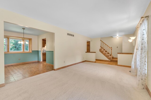 2145 Steeplechase Dr, Ann Arbor, MI 48103 - unfurnished room with a chandelier, stairs, and carpet
