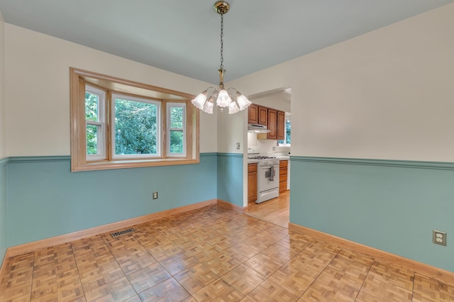 2145 Steeplechase Dr, Ann Arbor, MI 48103 - unfurnished room with a chandelier and plenty of natural light
