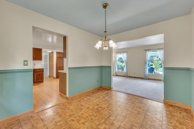 2145 Steeplechase Dr, Ann Arbor, MI 48103 - spare room featuring a chandelier and parquet flooring
