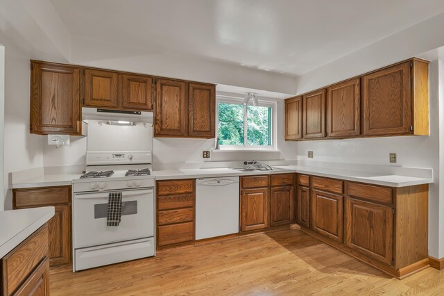2145 Steeplechase Dr, Ann Arbor, MI 48103 - kitchen featuring white appliances, under cabinet range hood, and brown cabinets
