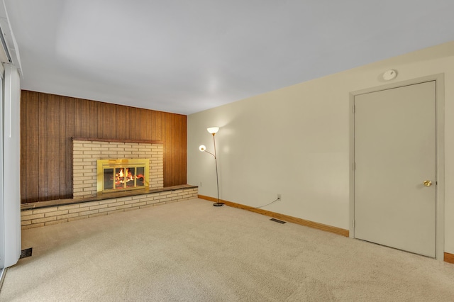 2145 Steeplechase Dr, Ann Arbor, MI 48103 - unfurnished living room featuring carpet flooring, wooden walls, and a brick fireplace